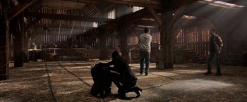 Movie still from “Jigsaw” (2017), directed by Michael Spierig – A man and a woman are in a barn; Wide shot, Over the shoulder angle