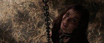 Movie still from “Jigsaw” (2017), directed by Michael Spierig – A woman holding a metal chain in her hand; Close Up shot, Over the shoulder angle