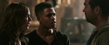 Movie still from “Jigsaw” (2017), directed by Michael Spierig – A person wearing a black shirt; Close Up shot, Over the shoulder angle