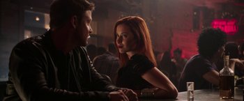 Movie still from “Jigsaw” (2017), directed by Michael Spierig – A man and a woman sitting at a table in front of each other holding hands; Close Up shot, Over the shoulder angle