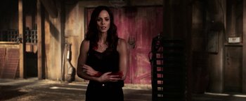 Movie still from “Jigsaw” (2017), directed by Michael Spierig – A woman in a black top with blood on her hands; Medium shot, Over the shoulder angle