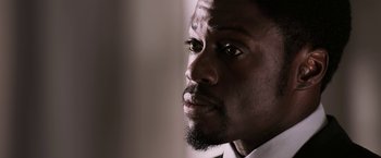 Movie still from “Jigsaw” (2017), directed by Michael Spierig – A person with a beard looking to his left; Close Up shot, Low angle