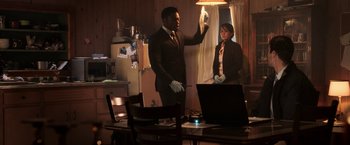 Movie still from “Jigsaw” (2017), directed by Michael Spierig – A man and a woman standing next to each other in front of a laptop; Medium shot, Low angle