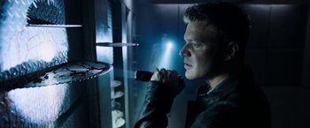 Movie still from “Jigsaw” (2017), directed by Michael Spierig – A man holding a cell phone up to his ear; Close Up shot, Low angle