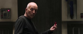 Movie still from “Jigsaw” (2017), directed by Michael Spierig – A man holding a cell phone in his hand; Close Up shot, Low angle