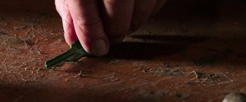 Movie still from “Jigsaw” (2017), directed by Michael Spierig – A person cutting a piece of wood with a knife; Extreme Close Up shot, High angle