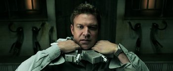 Movie still from “Jigsaw” (2017), directed by Michael Spierig – A man holding a camera in his hands; Close Up shot, Low angle