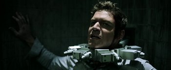 Movie still from “Jigsaw” (2017), directed by Michael Spierig – A man with a lot of cameras around his neck; Close Up shot, Over the shoulder angle