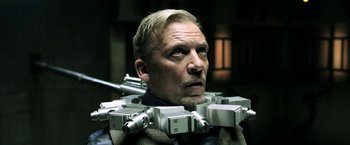 Movie still from “Jigsaw” (2017), directed by Michael Spierig – A person wearing a suit and tie; Close Up shot, Low angle