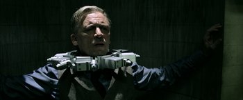 Movie still from “Jigsaw” (2017), directed by Michael Spierig – A man holding a camera in his hand; Medium shot, Low angle