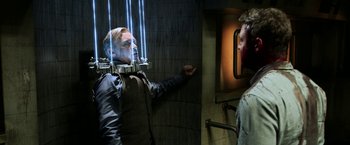 Movie still from “Jigsaw” (2017), directed by Michael Spierig – A man is standing in front of a bathroom mirror; Medium shot, Over the shoulder angle