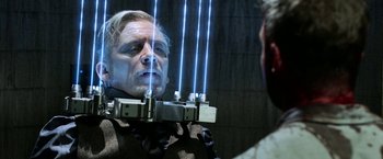 Movie still from “Jigsaw” (2017), directed by Michael Spierig – A man is reflected in a mirror with blue lights on his face; Close Up shot, Over the shoulder angle