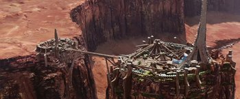 Movie still from “John Carter” (2012), directed by Andrew Stanton – An aerial view of a wooden structure in the middle of the desert; Extreme Wide shot, High angle