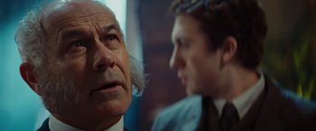 Movie still from “John Carter” (2012), directed by Andrew Stanton – A man in a suit and tie next to another man in a suit and tie; Close Up shot, Over the shoulder angle