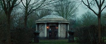 Movie still from “John Carter” (2012), directed by Andrew Stanton – Two men are standing in front of a building; Wide shot, Low angle