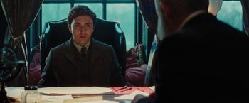 Movie still from “John Carter” (2012), directed by Andrew Stanton – A man sitting in front of a mirror in front of a window; Medium shot, Over the shoulder angle