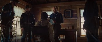 Movie still from “John Carter” (2012), directed by Andrew Stanton – A man and woman in a log cabin talking to each other; Medium shot, Over the shoulder angle