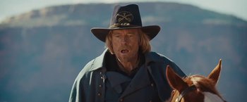 Movie still from “John Carter” (2012), directed by Andrew Stanton – A person wearing a hat; Close Up shot, Over the shoulder angle