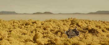 Movie still from “John Carter” (2012), directed by Andrew Stanton – A necklace in the middle of the desert; Extreme Close Up shot, Overhead angle