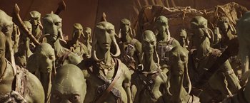 Movie still from “John Carter” (2012), directed by Andrew Stanton – A group of green people standing next to each other; Medium shot, High angle