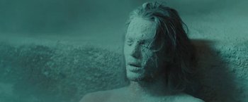 Movie still from “John Carter” (2012), directed by Andrew Stanton – A man is covered in sand in a bath tub; Close Up shot, High angle