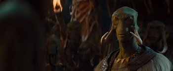 Movie still from “John Carter” (2012), directed by Andrew Stanton – A person with a bunch of statues in the background; Close Up shot, Over the shoulder angle