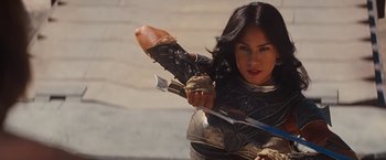 Movie still from “John Carter” (2012), directed by Andrew Stanton – A woman dressed as a warrior holding a bow and arrow; Medium shot, Over the shoulder angle