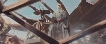 Movie still from “John Carter” (2012), directed by Andrew Stanton – A man in a long robe standing in front of an airplane; Medium shot, Low angle