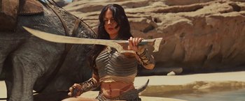 Movie still from “John Carter” (2012), directed by Andrew Stanton – A woman holding a sword in her hands; Medium shot, Low angle