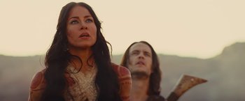 Movie still from “John Carter” (2012), directed by Andrew Stanton – A woman standing next to a man with long black hair; Close Up shot, Low angle