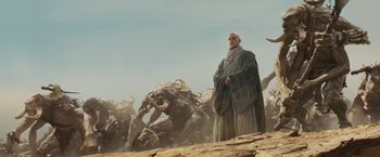 Movie still from “John Carter” (2012), directed by Andrew Stanton – A man standing in front of a herd of animals; Wide shot, Low angle
