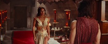 Movie still from “John Carter” (2012), directed by Andrew Stanton – A woman in a gold dress standing in front of a mirror; Medium shot, Over the shoulder angle