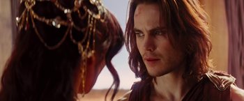 Movie still from “John Carter” (2012), directed by Andrew Stanton – A person with a horse in the background; Close Up shot, Over the shoulder angle