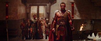 Movie still from “John Carter” (2012), directed by Andrew Stanton – A group of people in costumes in a room; Medium shot, Low angle