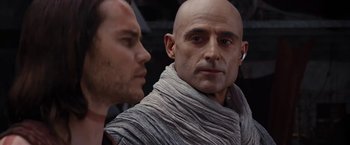 Movie still from “John Carter” (2012), directed by Andrew Stanton – A man with a shaved head and a man with a shaved head; Close Up shot, Over the shoulder angle