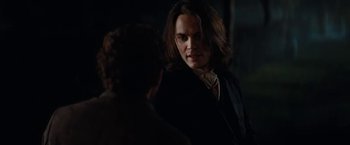 Movie still from “John Carter” (2012), directed by Andrew Stanton – A man with long black hair talking to another man; Close Up shot, Over the shoulder angle