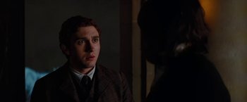 Movie still from “John Carter” (2012), directed by Andrew Stanton – A man in a suit and tie looking at the camera; Close Up shot, Over the shoulder angle