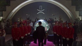 Movie still from “Johnny Mnemonic” (1995), directed by Robert Longo – A group of men in red jackets standing in front of a mirror; Wide shot, Low angle