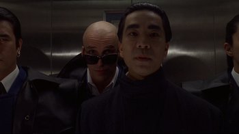 Movie still from “Johnny Mnemonic” (1995), directed by Robert Longo – A man in a black jacket and a bald man in a black jacket; Close Up shot, Low angle