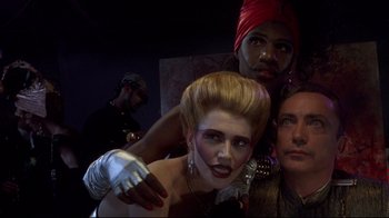 Movie still from “Johnny Mnemonic” (1995), directed by Robert Longo – A group of people standing next to each other in a room; Close Up shot, Low angle