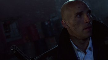 Movie still from “Johnny Mnemonic” (1995), directed by Robert Longo – A man with a shaved head looking up at the sky; Close Up shot, Low angle