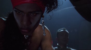 Movie still from “Johnny Mnemonic” (1995), directed by Robert Longo – A person wearing a red bandanna; Close Up shot, Low angle