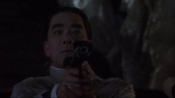 Movie still from “Johnny Mnemonic” (1995), directed by Robert Longo – A man is holding a cell phone up to his face; Close Up shot, Low angle