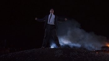 Movie still from “Johnny Mnemonic” (1995), directed by Robert Longo – A man standing on top of a hill at night; Wide shot, Low angle