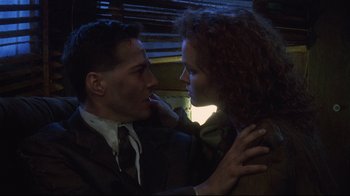 Movie still from “Johnny Mnemonic” (1995), directed by Robert Longo – A man and a woman are looking at one another; Close Up shot, Low angle