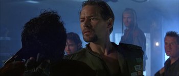 Movie still from “Judge Dredd” (1995), directed by Danny Cannon – A person in a room; Close Up shot, Over the shoulder angle