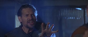 Movie still from “Judge Dredd” (1995), directed by Danny Cannon – A person holding something in his hand; Close Up shot, Low angle