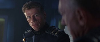 Movie still from “Judge Dredd” (1995), directed by Danny Cannon – A person wearing a uniform; Close Up shot, Over the shoulder angle