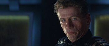 Movie still from “Judge Dredd” (1995), directed by Danny Cannon – A person wearing a police uniform; Close Up shot, Over the shoulder angle