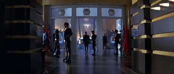 Movie still from “Judge Dredd” (1995), directed by Danny Cannon – A group of people standing in front of a building; Wide shot, High angle